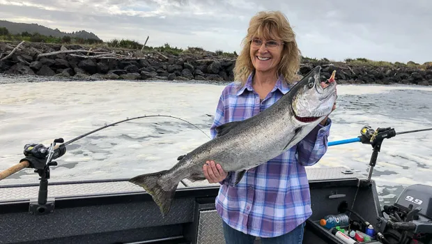 Happy lady with her Chinook salmon in Tillamook Bay